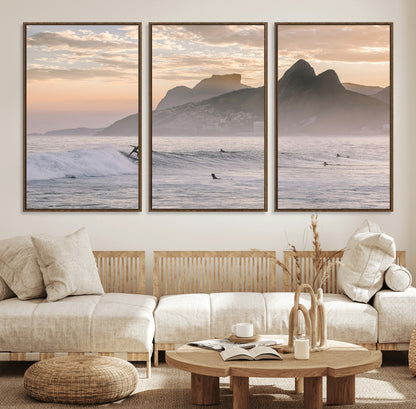 A surfer rides a golden hour wave near misty coastal mountains, surrounded by fellow surfers, capturing the spirit of a coastal adventure.