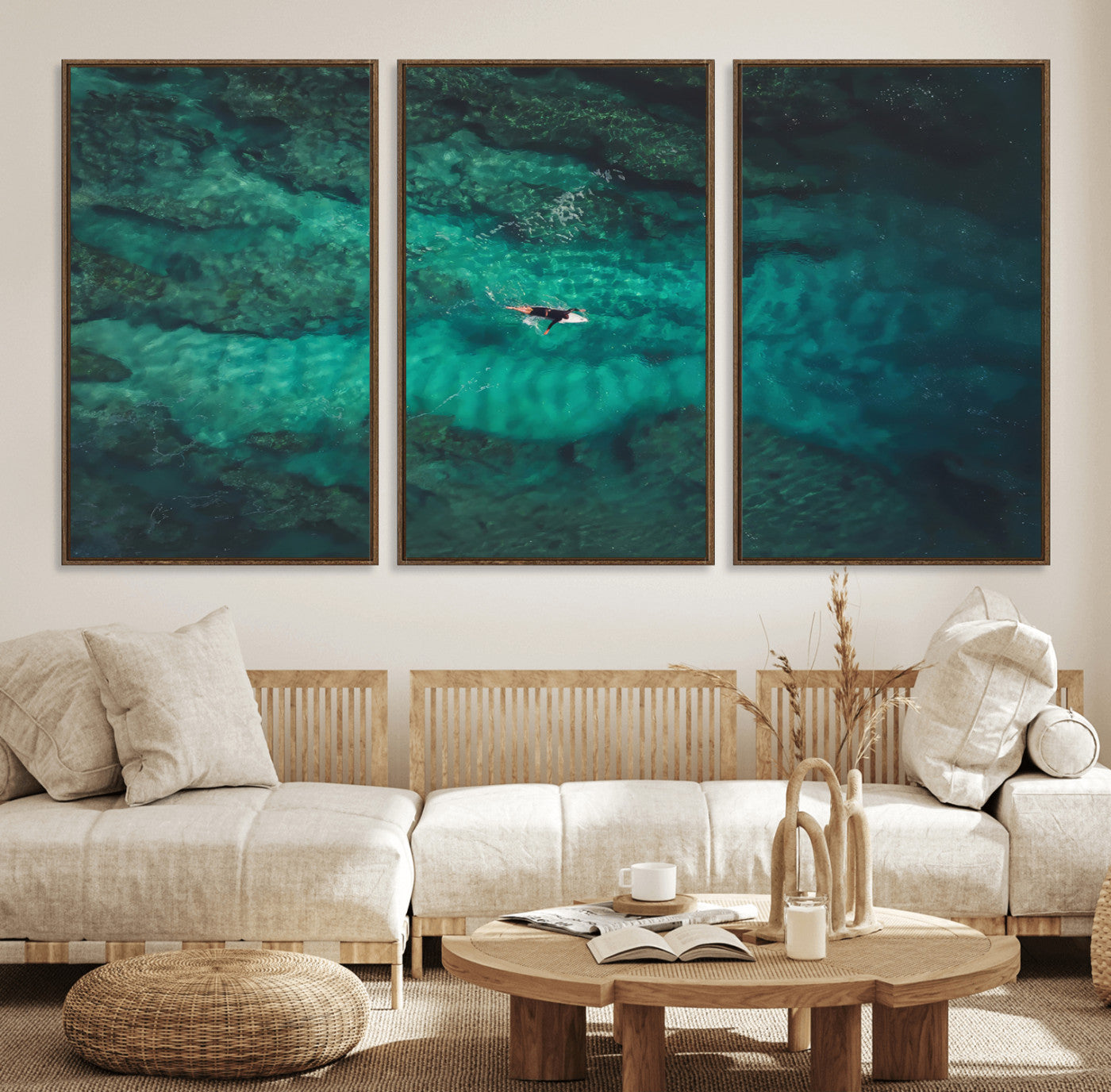 An aerial view of a solo surfer paddling through crystal-clear turquoise waters over a sunlit reef, capturing the beauty and serenity of open water surfing.