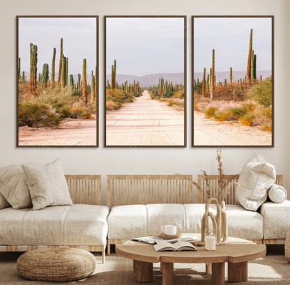 A desert road lined with saguaro cacti under a golden sky, creating a warm southwestern feel, perfect for boho or rustic decor.