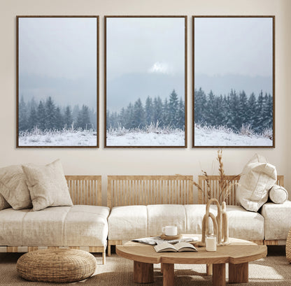 Snow-covered forest under misty sky, soft light breaking through clouds, ideal for minimalist or Nordic-inspired home decor.