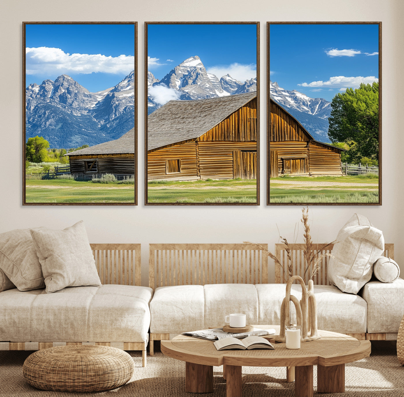 A rustic wooden barn sits in front of towering mountain peaks under a clear blue sky, perfect for farmhouse or cabin style interiors.