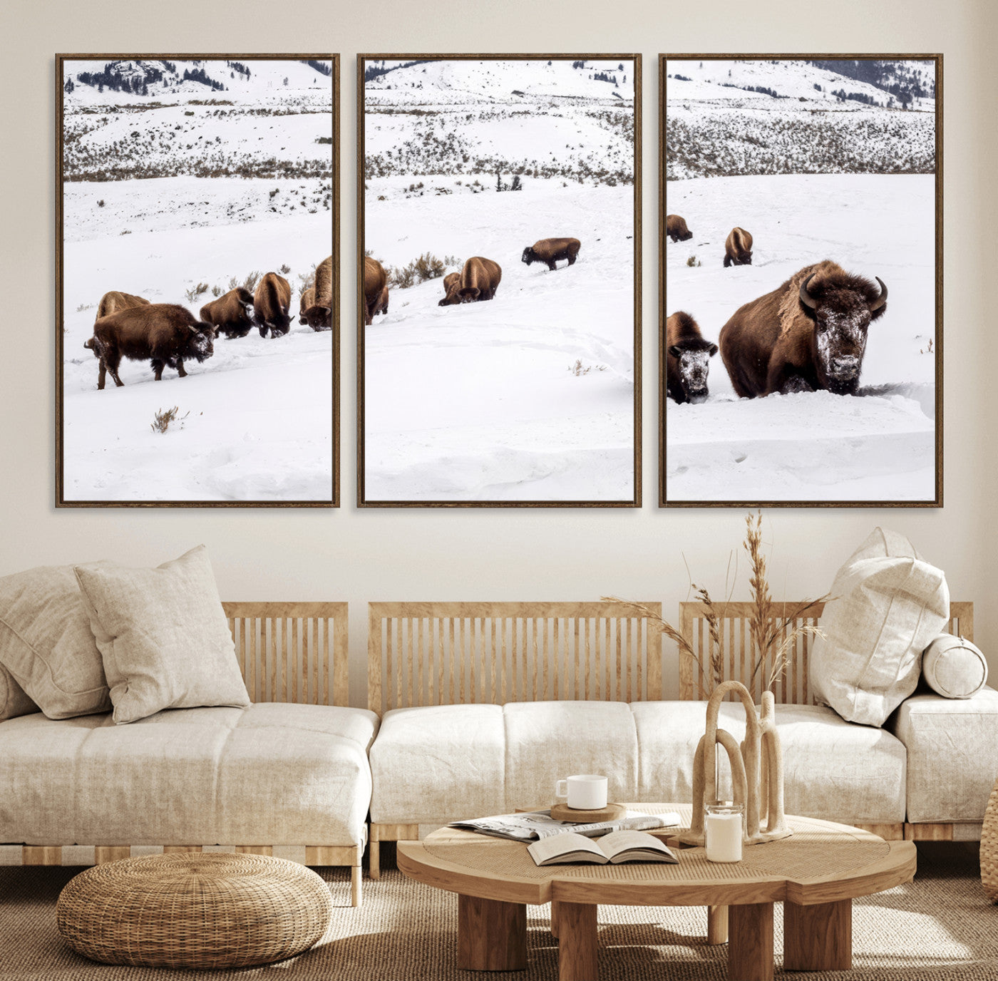 A herd of bison walking through deep snow in a mountain valley, perfect for rustic, cabin or western-themed wall decor.