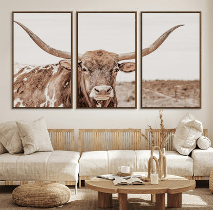 A longhorn cow in soft beige desert tones, standing calmly in open land, perfect for neutral western or rustic farmhouse interiors.