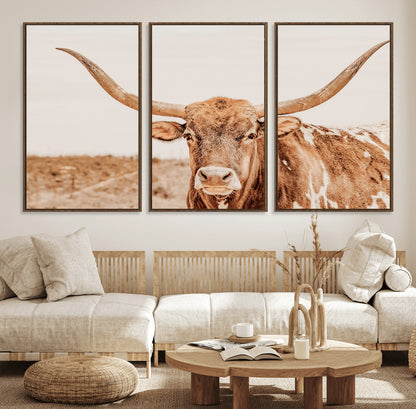 A longhorn bull standing proudly in a sunlit desert field with warm neutral tones, ideal for rustic western or farmhouse interiors.