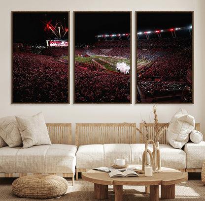 A dramatic shot of a packed stadium at night, with fireworks and smoke creating an exciting atmosphere for a live football game.