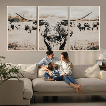 Canvas of a speckled Texas longhorn standing boldly in a field with a herd behind, perfect for rustic western or farmhouse wall decor.