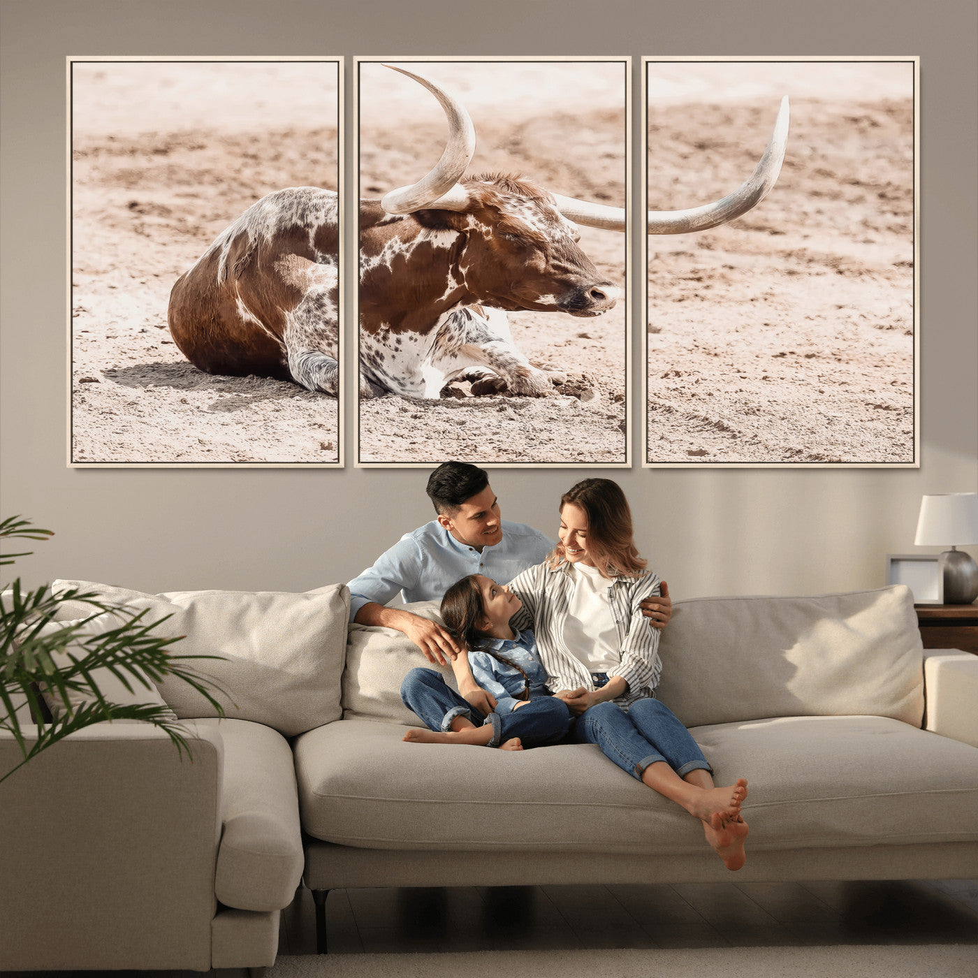 Texas Longhorn bull resting on dusty ground with warm tones, ideal for rustic western or farmhouse-themed wall decor.