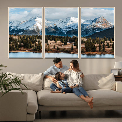 Framed canvas of snowy mountain peaks with pine forest and alpine lake, perfect for winter cabin or wilderness-inspired home decor.