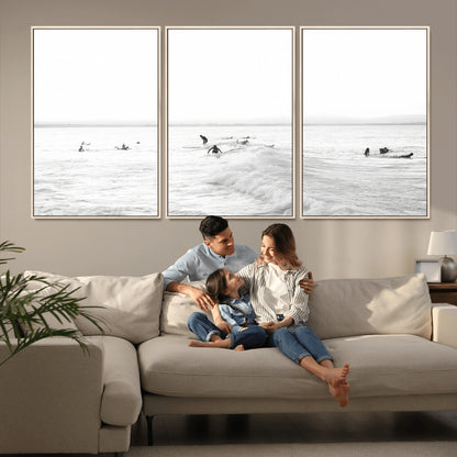 Monochrome photo of surfers riding and waiting on ocean waves, ideal for surf-themed or coastal energy wall decor.