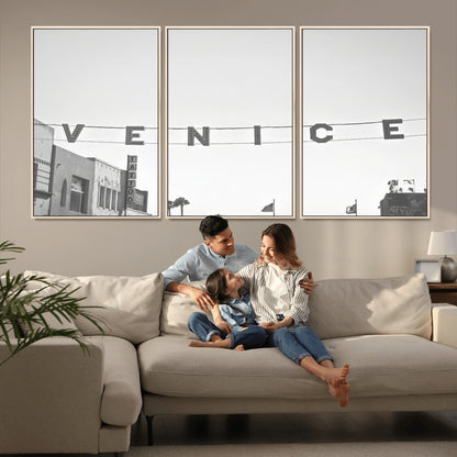 Black and white photo of Venice Beach sign and palm-lined street, perfect for urban coastal or minimalist LA-inspired wall decoration.