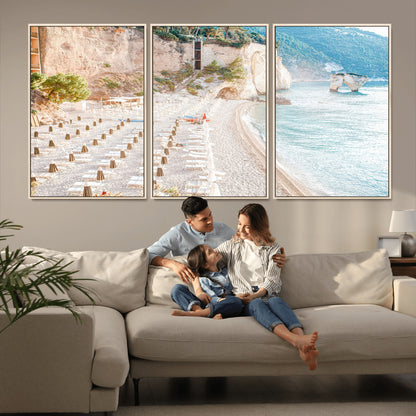 Wall art of a calm Mediterranean beach with rows of sun loungers and umbrellas in soft pastel tones, perfect for light coastal or vacation-themed decor.