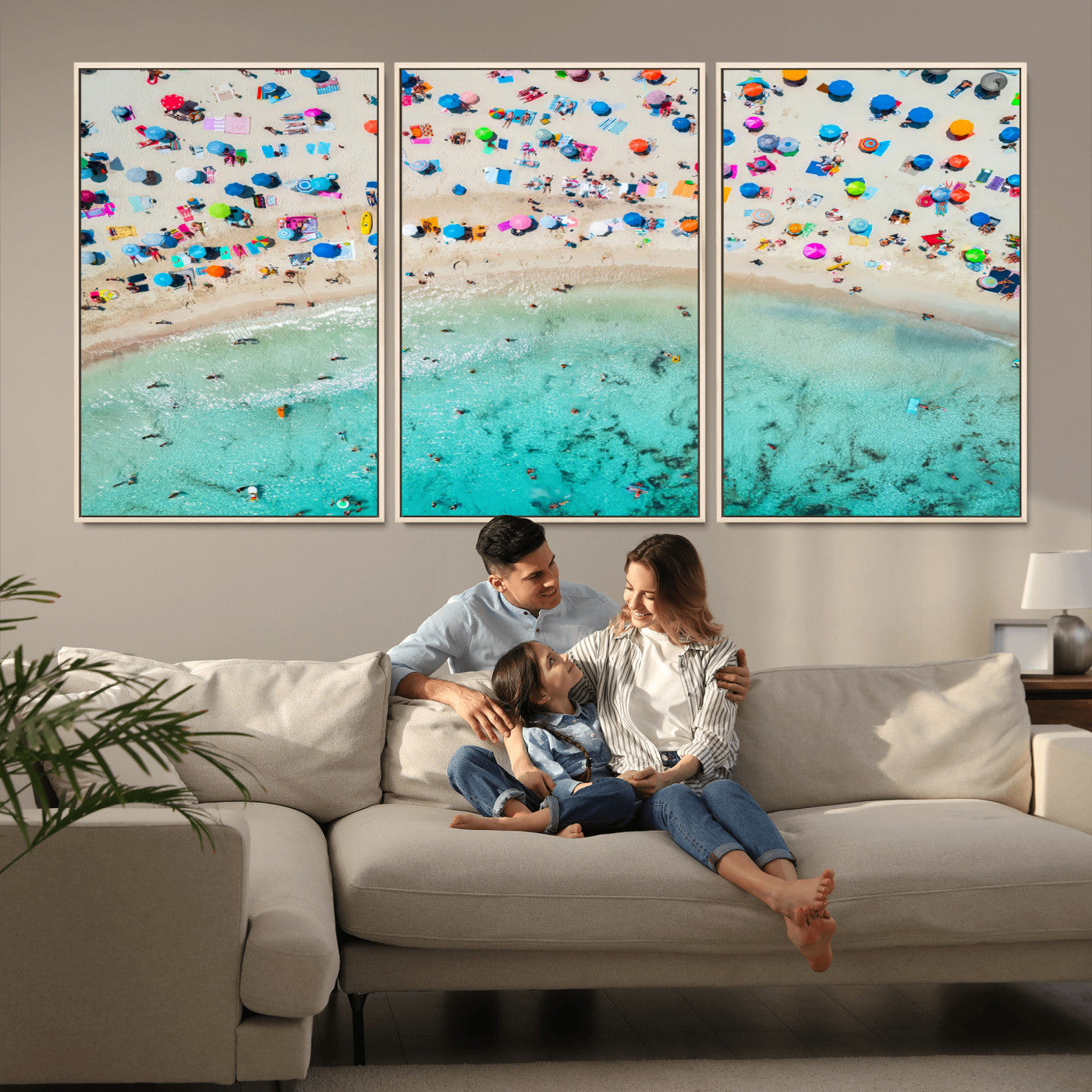 Aerial view of a vibrant beach filled with colorful umbrellas and people enjoying the turquoise ocean, capturing a lively summer vacation scene.