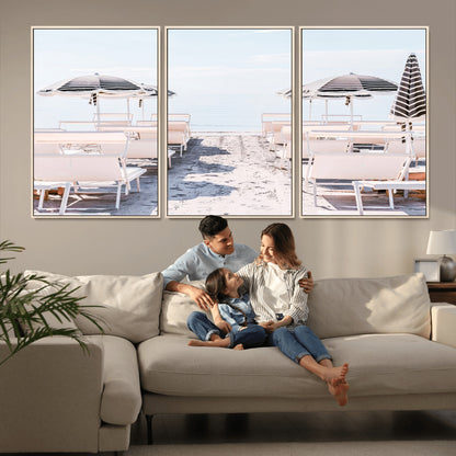 A serene minimalist beach scene featuring striped umbrellas, soft pastel sand, and an elegant lounge setup, creating a tranquil and stylish coastal retreat.
