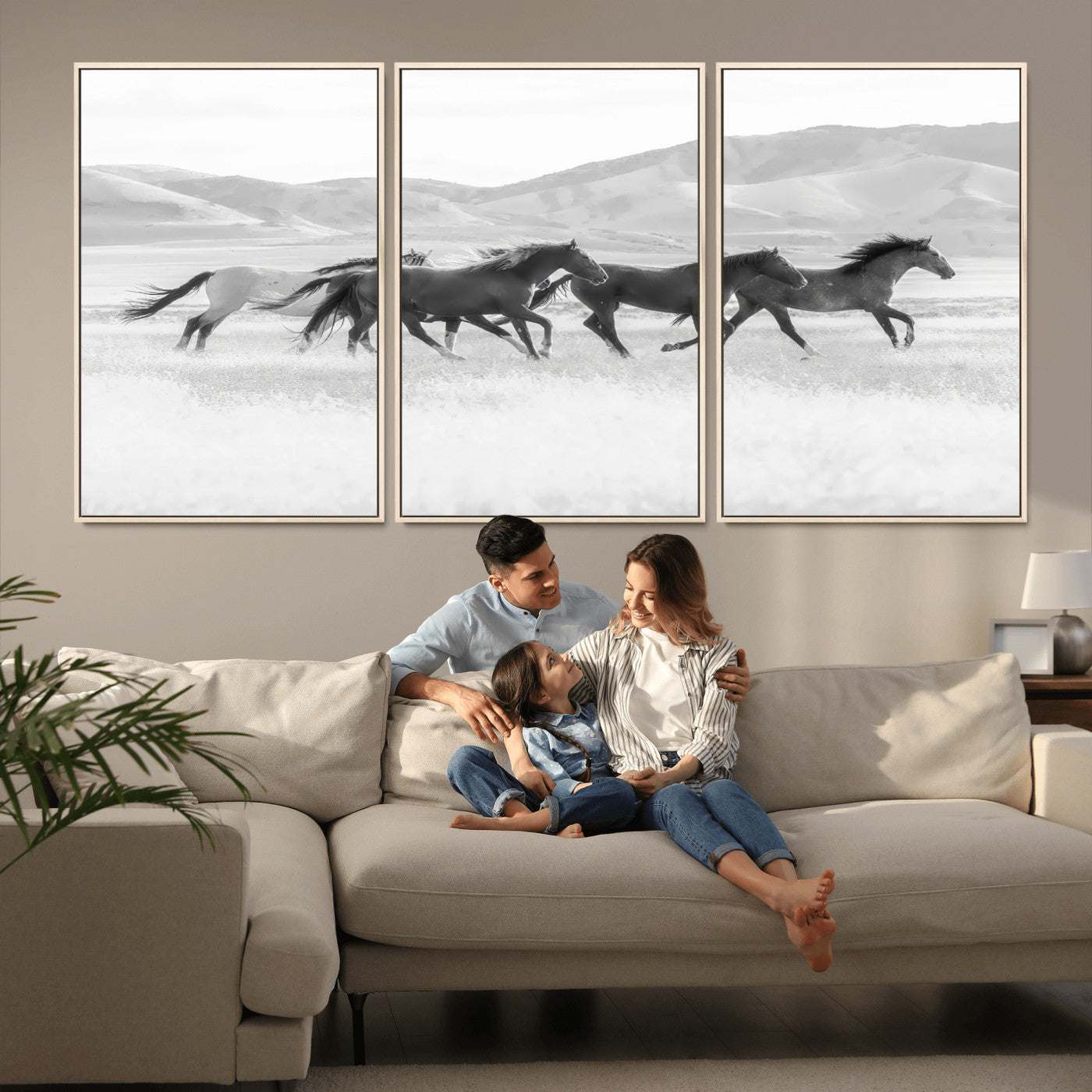 A black and white image of wild horses running freely across an open grassland, capturing the power and beauty of untamed nature in a rustic western setting.