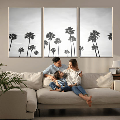 A black and white minimalist scene featuring tall palm trees silhouetted against a bright sky, creating a dreamy and timeless tropical aesthetic.