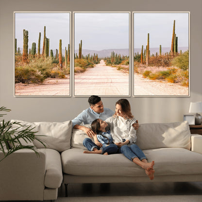 A desert road lined with saguaro cacti under a golden sky, creating a warm southwestern feel, perfect for boho or rustic decor.