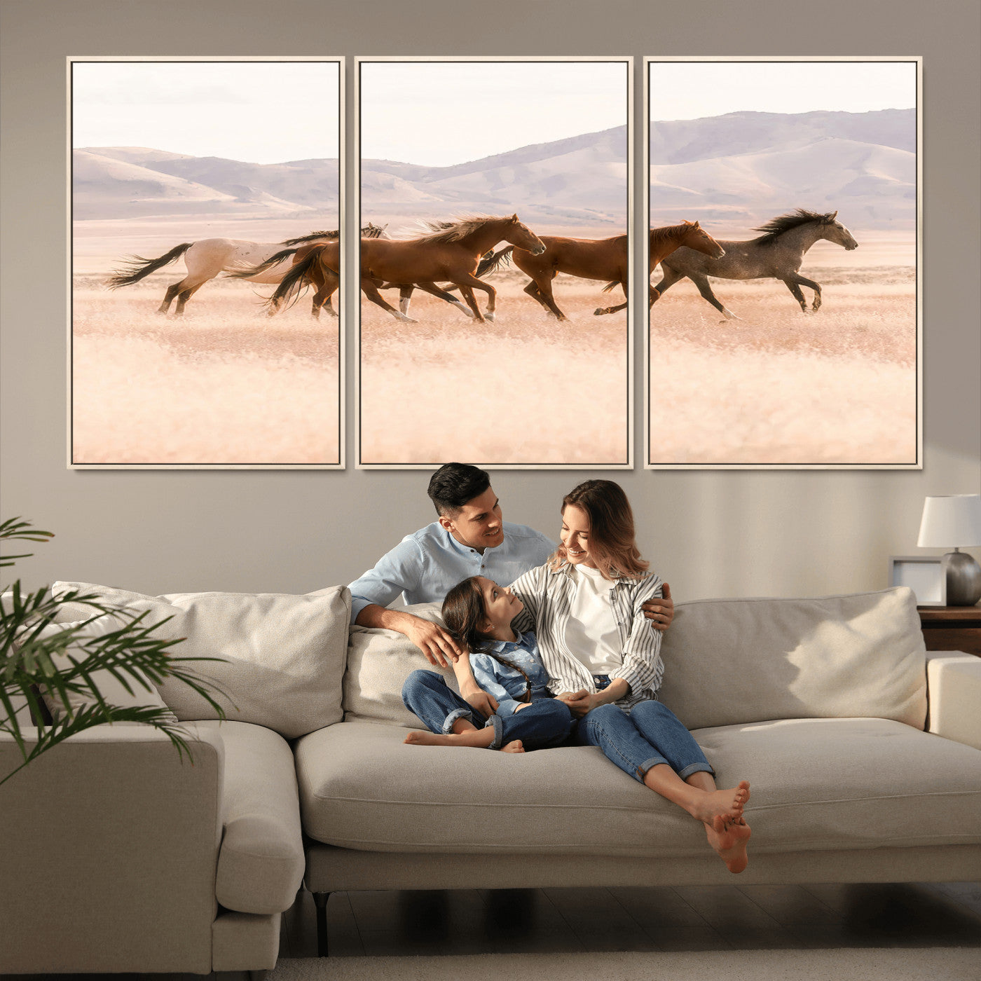 A herd of wild horses galloping through a sunlit desert plain with mountains in the background, perfect for rustic or western-themed wall decor.