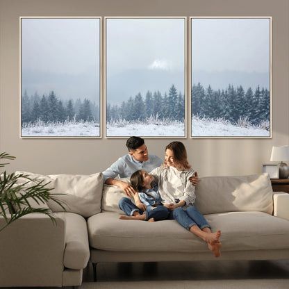 Snow-covered forest under misty sky, soft light breaking through clouds, ideal for minimalist or Nordic-inspired home decor.