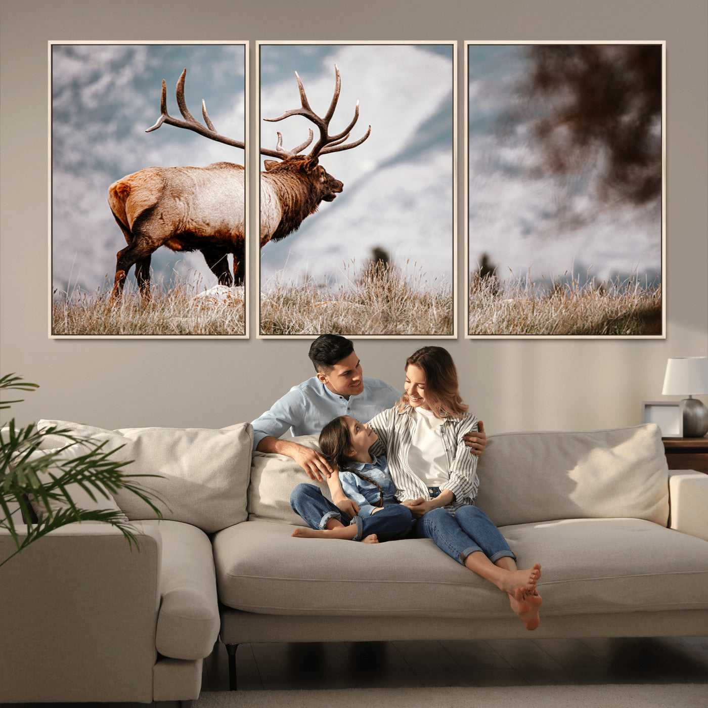 Majestic elk with large antlers standing in grass with snowy mountains in background, perfect for rustic cabin or lodge style decor.