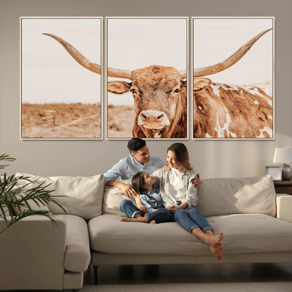 A longhorn bull standing proudly in a sunlit desert field with warm neutral tones, ideal for rustic western or farmhouse interiors.