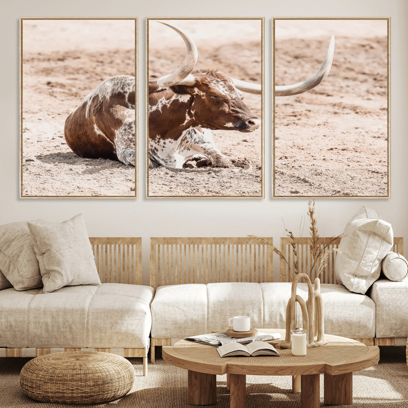 Texas Longhorn bull resting on dusty ground with warm tones, ideal for rustic western or farmhouse-themed wall decor.