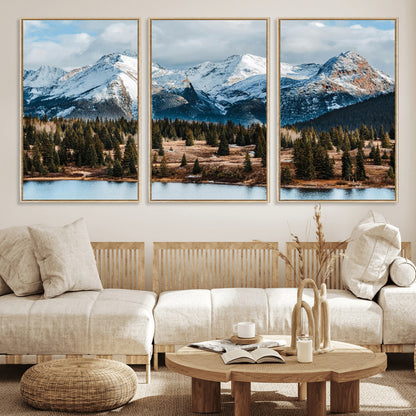 Framed canvas of snowy mountain peaks with pine forest and alpine lake, perfect for winter cabin or wilderness-inspired home decor.