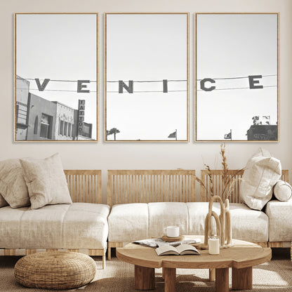 Black and white photo of Venice Beach sign and palm-lined street, perfect for urban coastal or minimalist LA-inspired wall decoration.