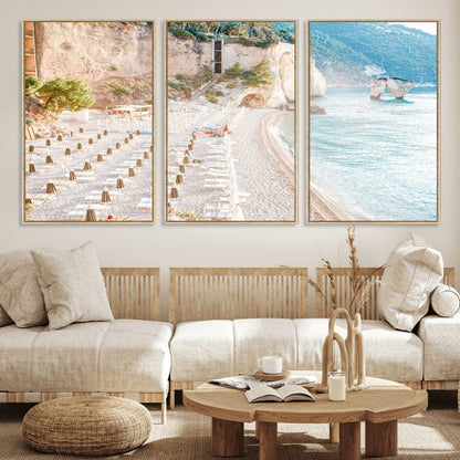 Wall art of a calm Mediterranean beach with rows of sun loungers and umbrellas in soft pastel tones, perfect for light coastal or vacation-themed decor.