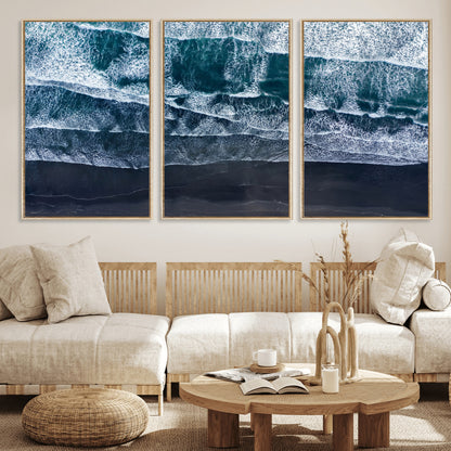 Canvas of aerial ocean waves crashing onto a black sand beach in moody tones, ideal for modern coastal or minimalist home decor.
