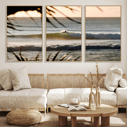 Photo of a surfer riding a golden hour wave at sunset, with tropical tones and dreamy light, perfect for tropical boho or coastal home decor.