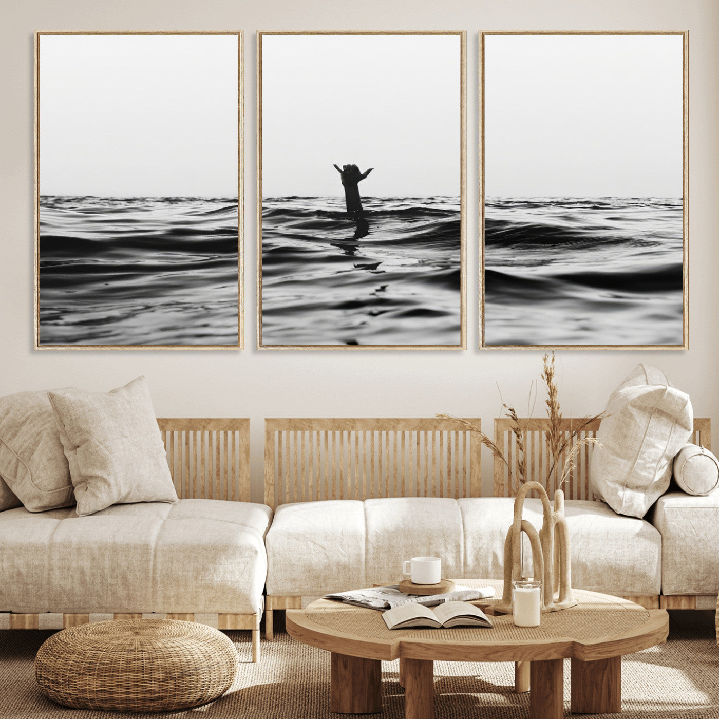 Black and white ocean with a hand making a surfer sign among dark waves, creating a dramatic and minimalist seascape with bold contrast.