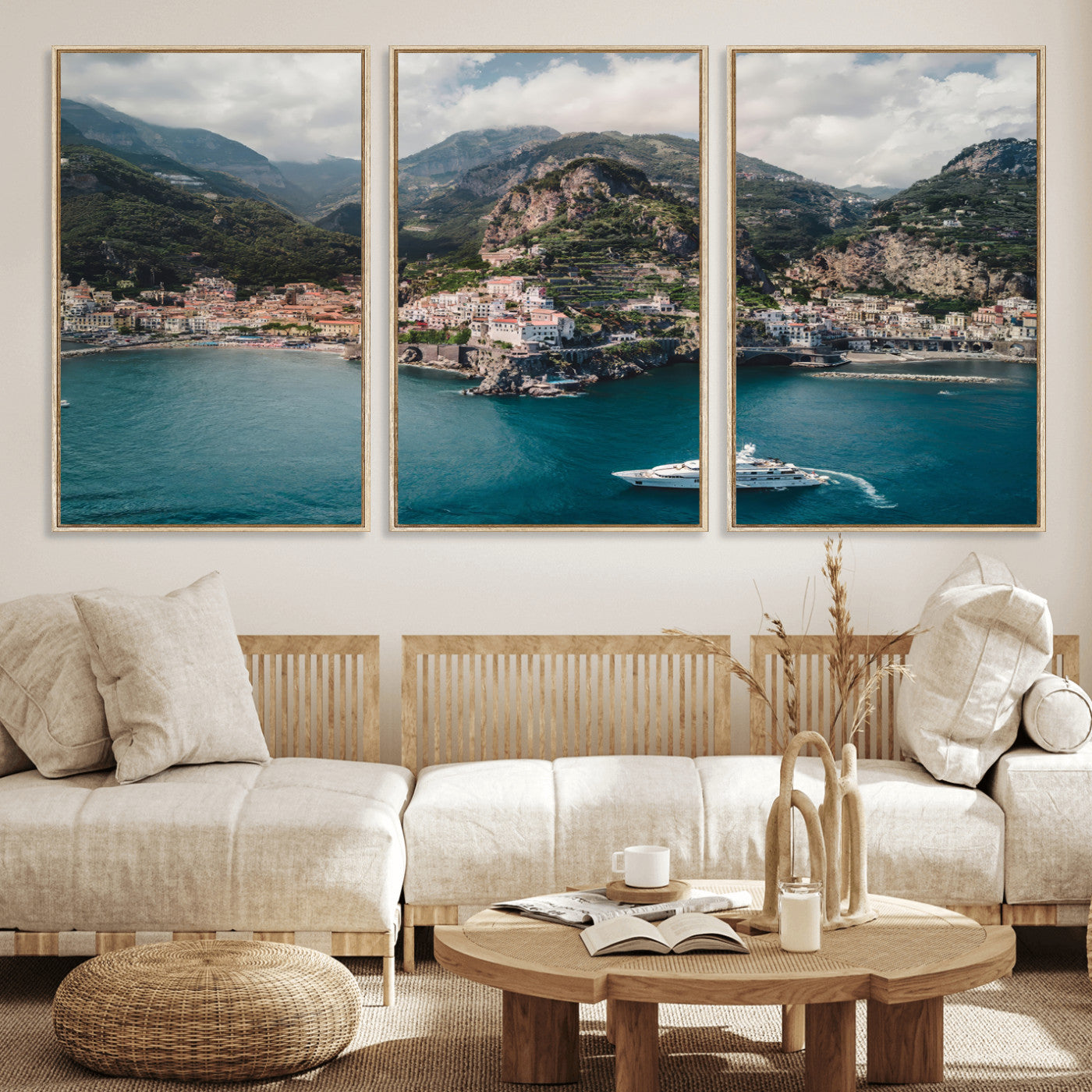 Aerial view of Amalfi Coast, Italy, with colorful hillside houses, lush green mountains, and a luxury yacht sailing in turquoise waters.