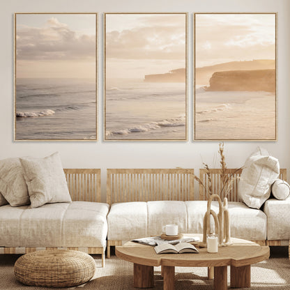 Golden hour seascape with misty cliffs and gentle waves rolling towards the shore, capturing a tranquil and warm coastal atmosphere.