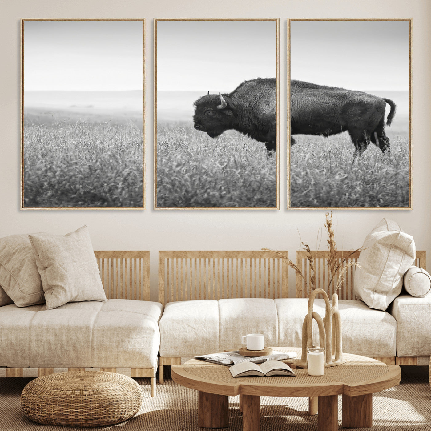 A black and white photograph of a majestic bison standing in a vast grassy prairie, evoking a sense of wilderness and strength.