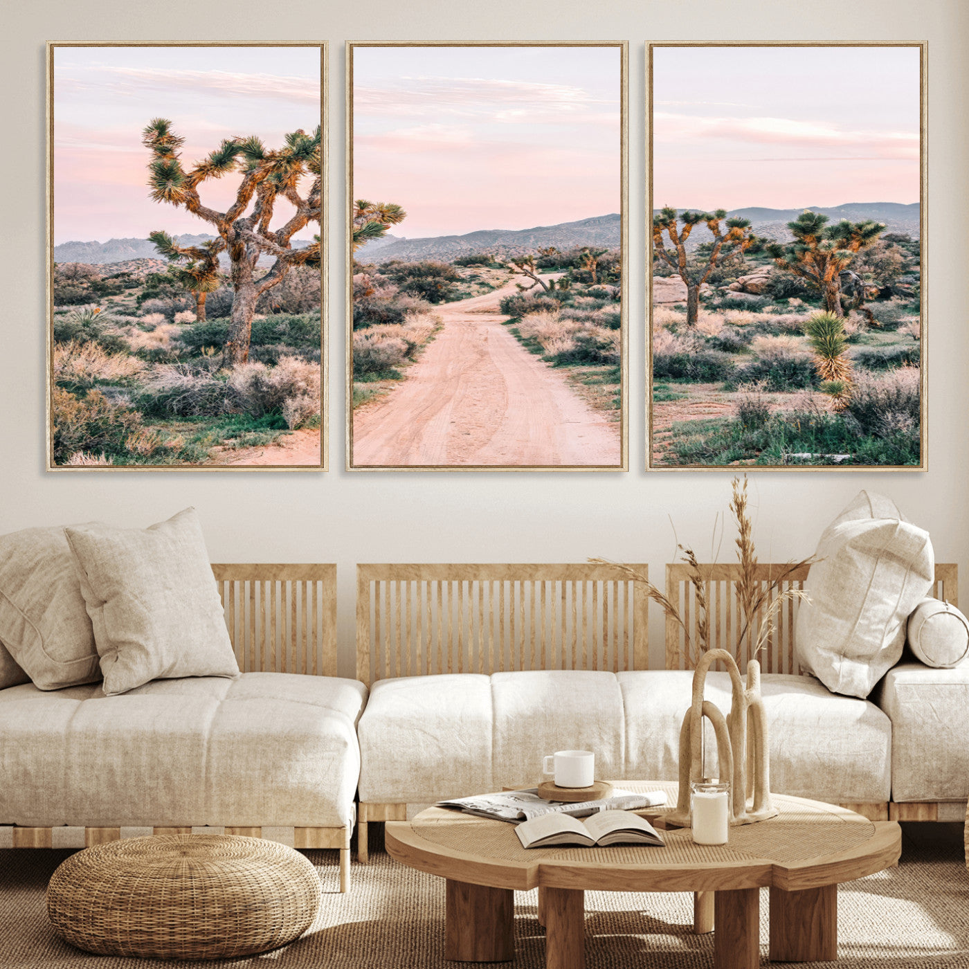 A dusty road winding through Joshua Tree National Park, framed by iconic twisted trees and warm desert tones under a soft pastel sky.