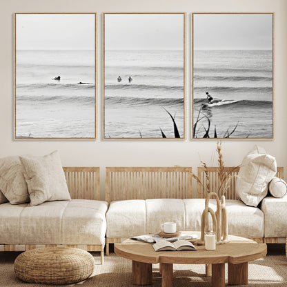 Monochrome canvas of surfers on calm ocean waves, ideal for minimalist coastal or beach-inspired interior decor.