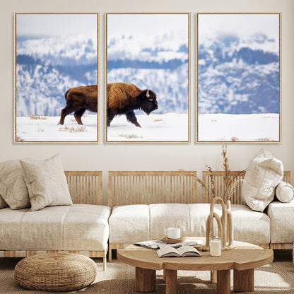 A lone bison walks across snowy ground with blue-toned mountain range behind, ideal for rustic or western farmhouse interiors.