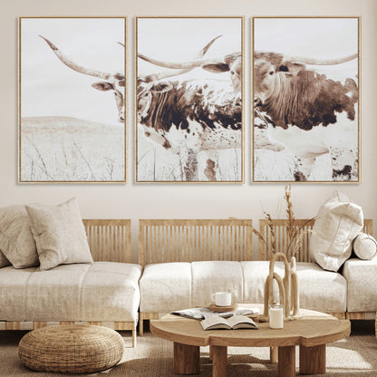 Two longhorn cows standing in a sepia-toned pasture with soft light, ideal for rustic or farmhouse-themed neutral wall decor.