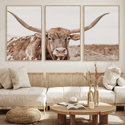 A longhorn cow in soft beige desert tones, standing calmly in open land, perfect for neutral western or rustic farmhouse interiors.