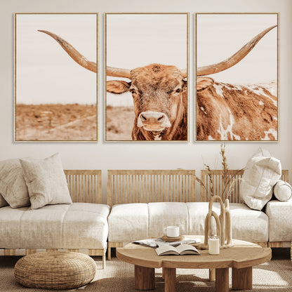 A longhorn bull standing proudly in a sunlit desert field with warm neutral tones, ideal for rustic western or farmhouse interiors.