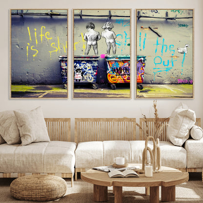 Graffiti-style canvas art with bold text and two naked figures over urban dumpsters, ideal for edgy or street-style decor.