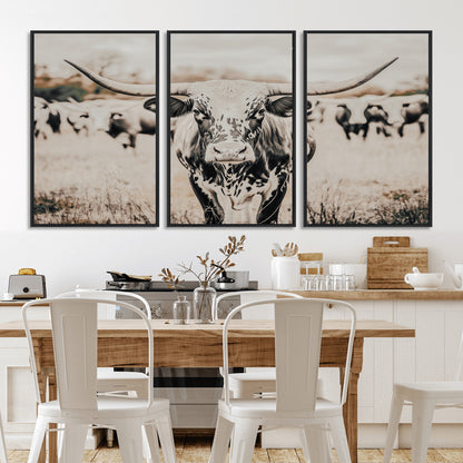 Canvas of a speckled Texas longhorn standing boldly in a field with a herd behind, perfect for rustic western or farmhouse wall decor.