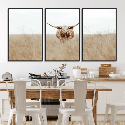 Texas Longhorn bull standing alone in dry grass with neutral tones, ideal for rustic western or cowboy-themed wall decor.