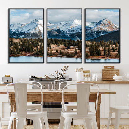 Framed canvas of snowy mountain peaks with pine forest and alpine lake, perfect for winter cabin or wilderness-inspired home decor.