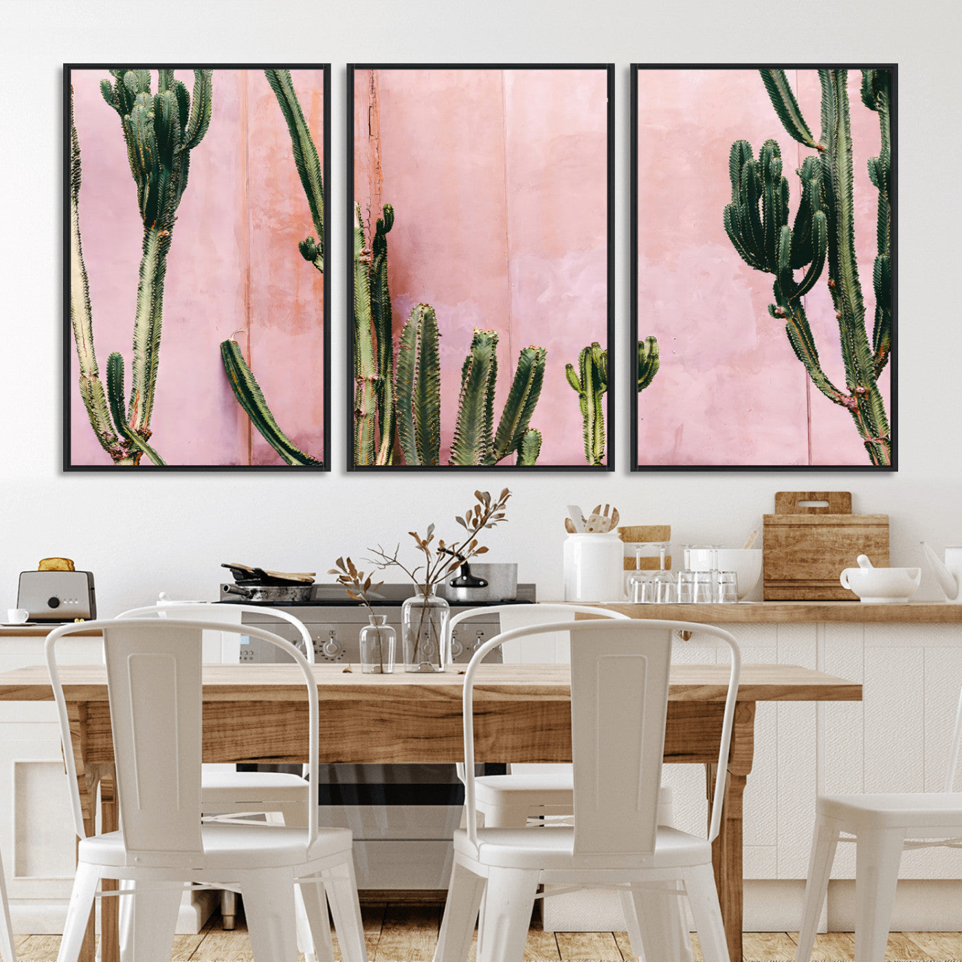 Framed canvas of tall green cacti against a soft pink wall, ideal for modern desert or colorful southwest-inspired home decor.