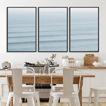 Framed canvas of repeating ocean waves with a distant solo surfer, ideal for minimalist ocean or calm coastal wall decor.