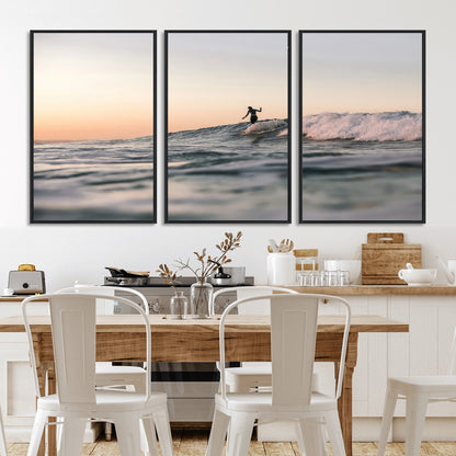 Framed canvas of a female surfer balancing on a wave at sunset, perfect for serene surf or ocean-inspired coastal decor.