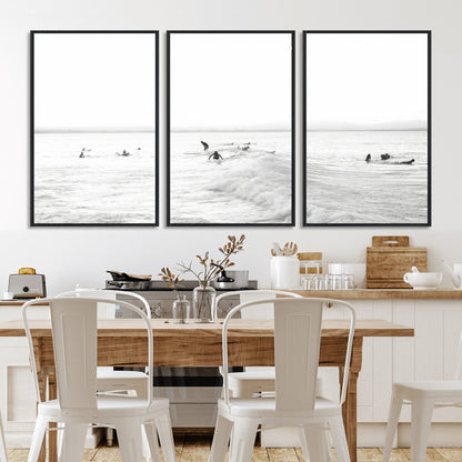Monochrome photo of surfers riding and waiting on ocean waves, ideal for surf-themed or coastal energy wall decor.
