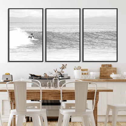 Monochrome photo of a surfer riding a wave with distant mountains, ideal for coastal motion or black and white surf-themed wall decor.