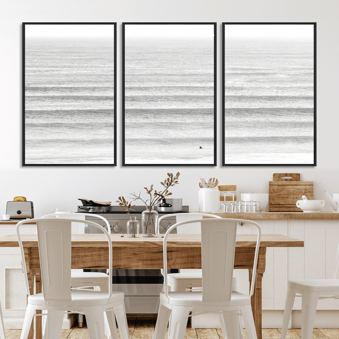 Monochrome photo of a lone surfer in calm layered waves, perfect for minimalist coastal or moody ocean-inspired wall decoration.